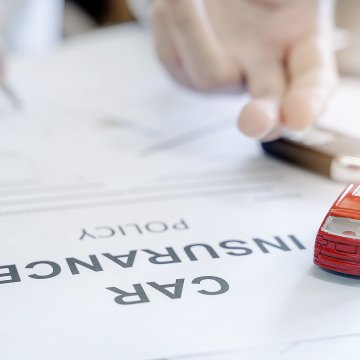 Car auto insurance contract with toy car on top 